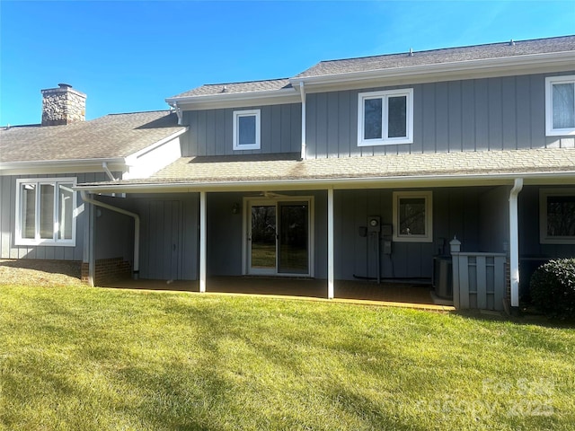 rear view of house featuring a lawn