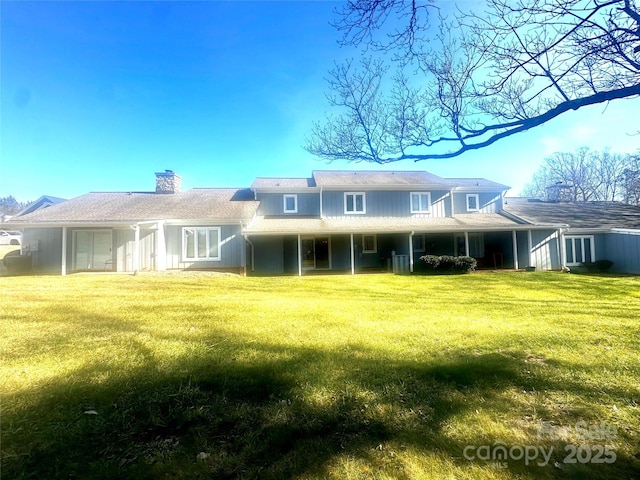 back of house with a lawn