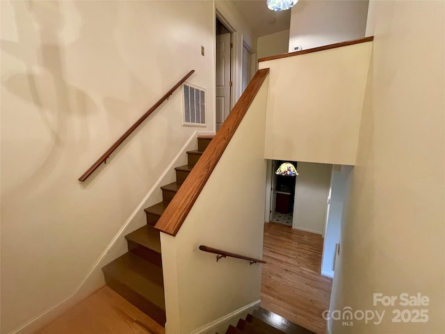 stairs with wood-type flooring