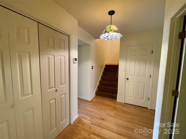 stairs with hardwood / wood-style flooring