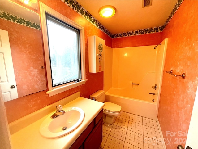 full bathroom featuring shower / bathtub combination, vanity, and toilet