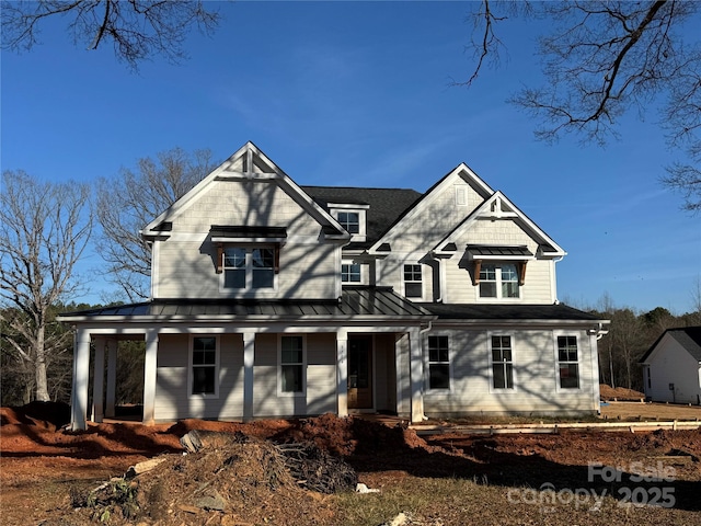 view of front of house with covered porch, metal roof, and a standing seam roof