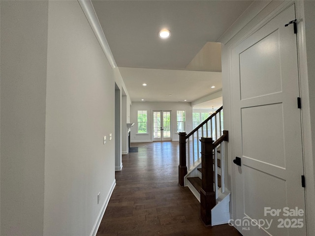hall featuring recessed lighting, dark wood-type flooring, stairs, and baseboards