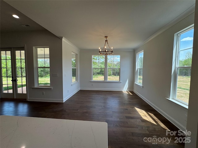 unfurnished dining area featuring a chandelier, crown molding, baseboards, and dark wood-style flooring