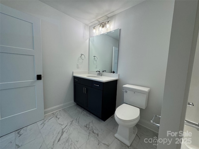 bathroom featuring baseboards, marble finish floor, vanity, and toilet