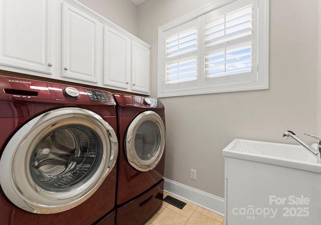 clothes washing area featuring cabinets, washer and clothes dryer, sink, and light tile patterned floors