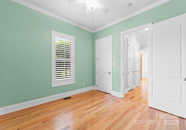 unfurnished bedroom featuring crown molding, ceiling fan, and light hardwood / wood-style floors