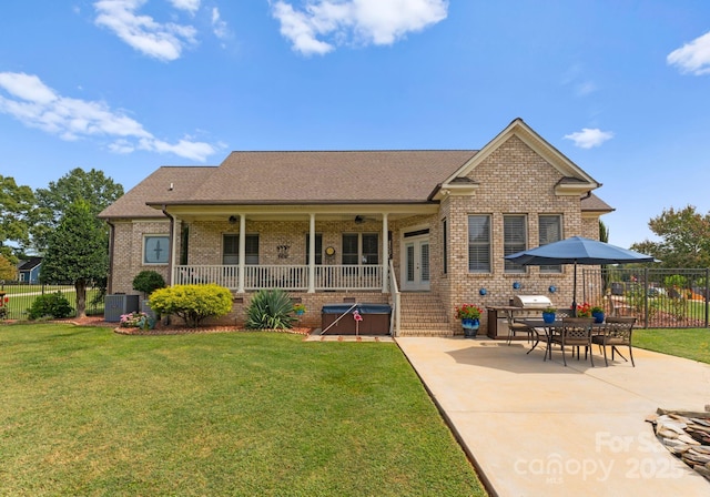 rear view of property with a yard, central AC, and a patio