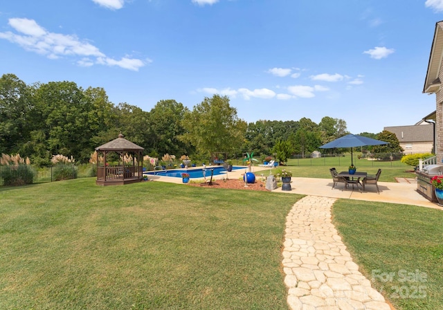 view of yard with a gazebo, a fenced in pool, and a patio