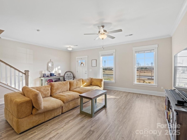 living room with crown molding, ceiling fan, and light hardwood / wood-style flooring