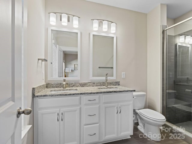 bathroom featuring vanity, toilet, and walk in shower