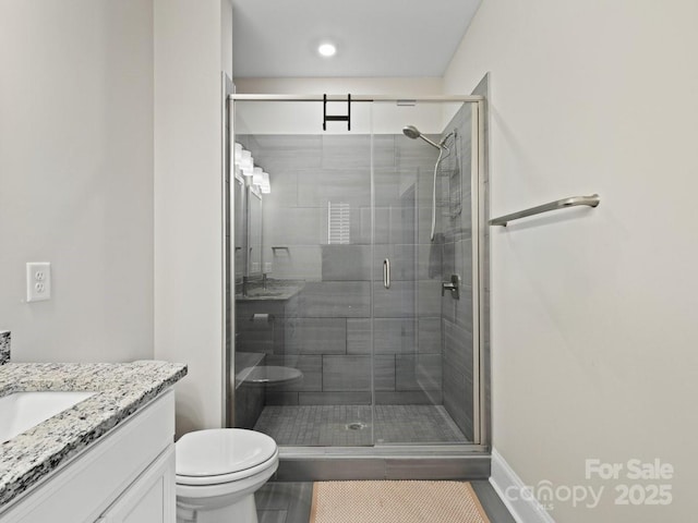 bathroom featuring vanity, walk in shower, and toilet