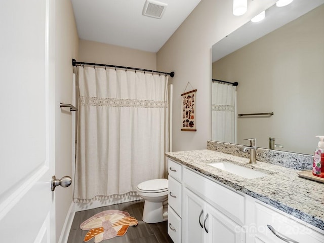 bathroom with vanity, wood-type flooring, and toilet