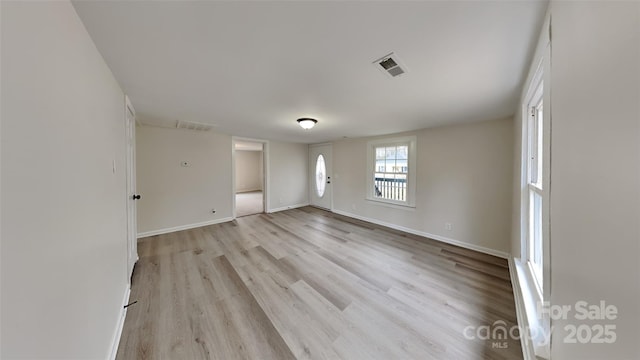 unfurnished room with light hardwood / wood-style floors