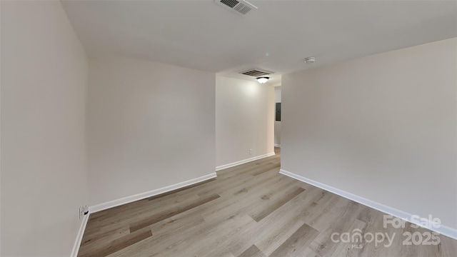 unfurnished room with light wood-type flooring