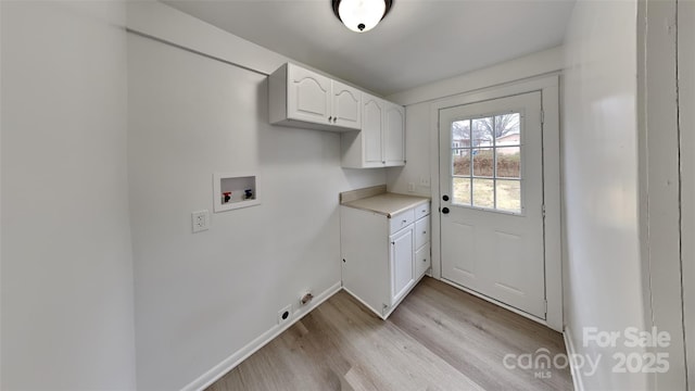 laundry room featuring washer hookup, cabinets, and light wood-type flooring