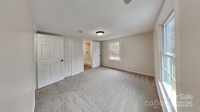 unfurnished bedroom featuring light carpet