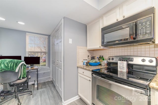 kitchen featuring white cabinetry, stainless steel range with electric stovetop, tasteful backsplash, light wood-type flooring, and light stone countertops