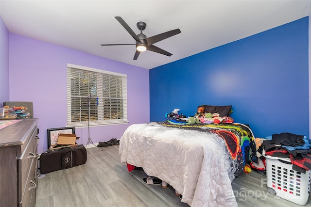 bedroom featuring ceiling fan and light wood-type flooring