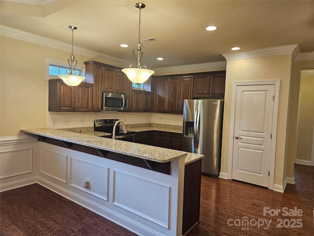 kitchen featuring dark brown cabinets, stainless steel appliances, light stone counters, decorative light fixtures, and kitchen peninsula