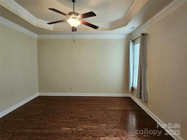 spare room with dark hardwood / wood-style floors, ornamental molding, a raised ceiling, and ceiling fan