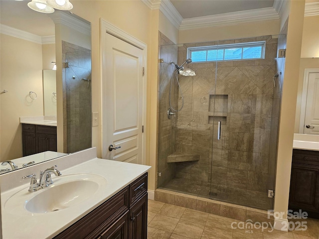 bathroom with vanity, crown molding, and a shower with shower door