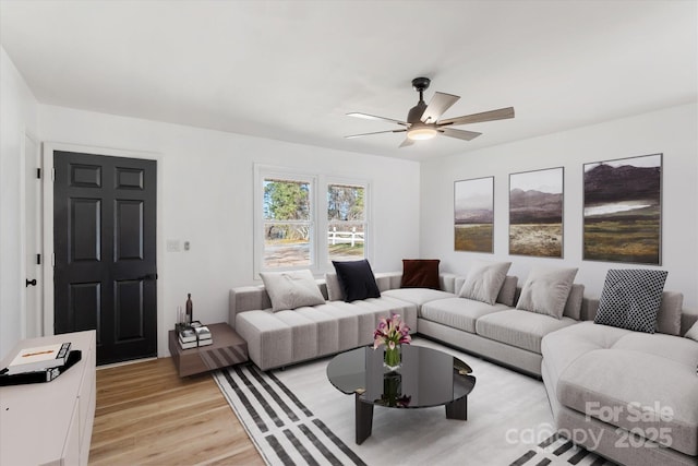 living room featuring ceiling fan and light hardwood / wood-style floors