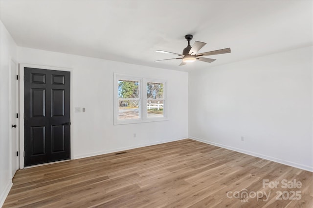 unfurnished room with hardwood / wood-style floors and ceiling fan