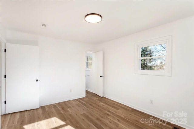 empty room with wood-type flooring