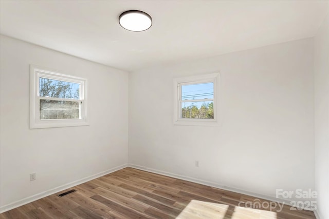 unfurnished room with hardwood / wood-style floors