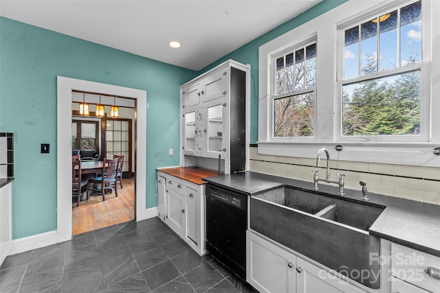 kitchen with white cabinetry, sink, a healthy amount of sunlight, and black dishwasher