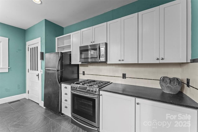 kitchen with appliances with stainless steel finishes, white cabinets, and decorative backsplash