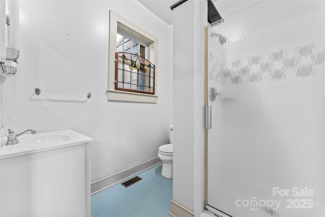 bathroom featuring an enclosed shower, vanity, and toilet