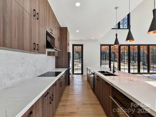 kitchen with pendant lighting, sink, range hood, light hardwood / wood-style floors, and black electric cooktop