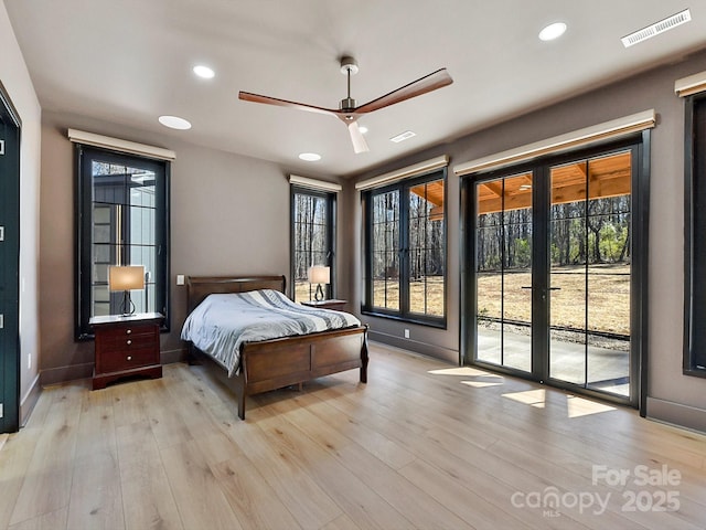 bedroom with multiple windows, access to exterior, ceiling fan, and light hardwood / wood-style flooring