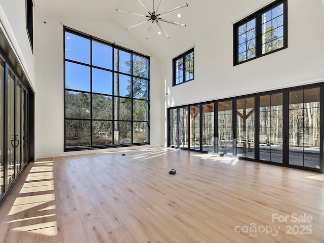 unfurnished living room featuring light hardwood / wood-style flooring and a chandelier