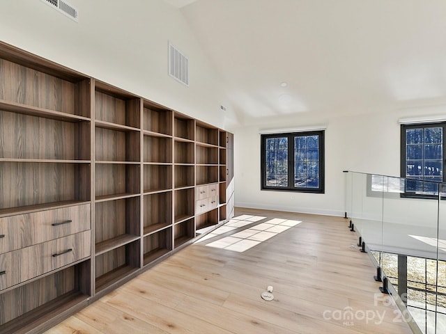 interior space with vaulted ceiling and light wood-type flooring