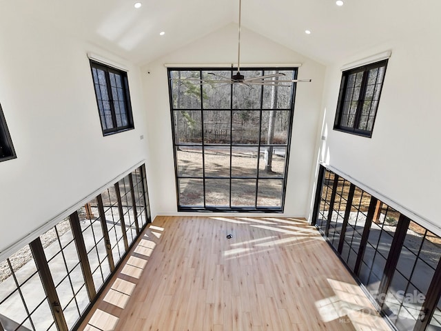 interior space featuring hardwood / wood-style flooring, high vaulted ceiling, and a wealth of natural light