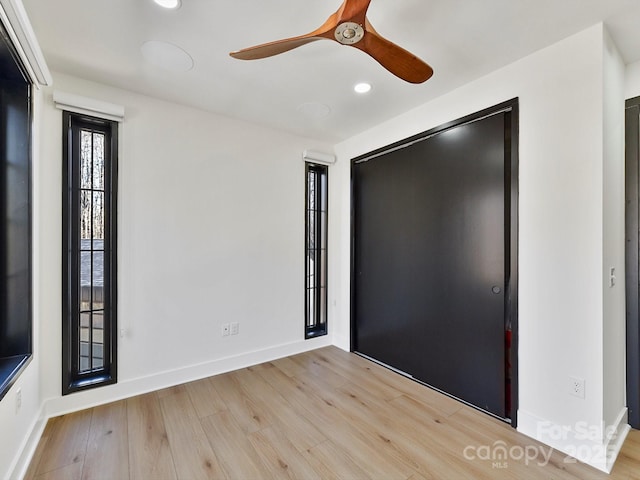 unfurnished bedroom featuring ceiling fan and light wood-type flooring