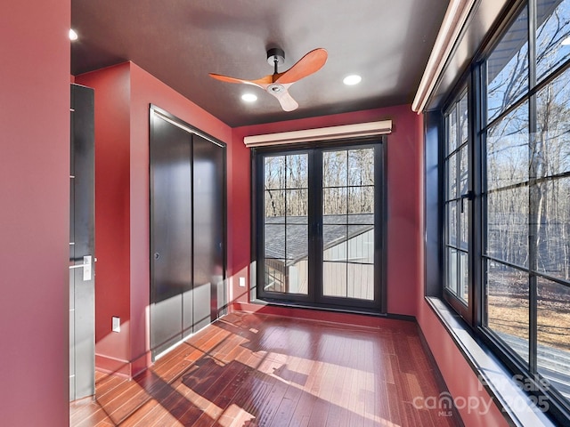 doorway featuring hardwood / wood-style flooring and ceiling fan