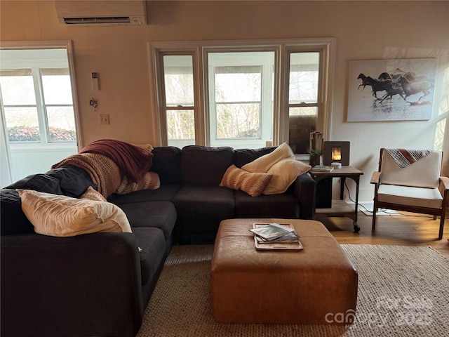 living room featuring hardwood / wood-style floors and an AC wall unit