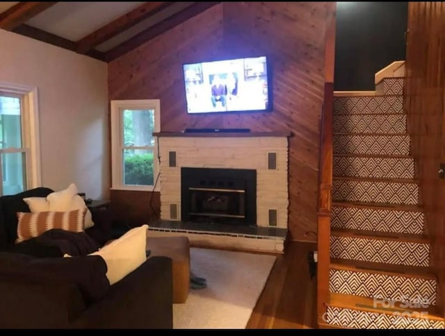 living room featuring vaulted ceiling with beams