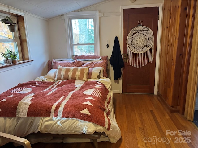 bedroom featuring wood-type flooring and vaulted ceiling