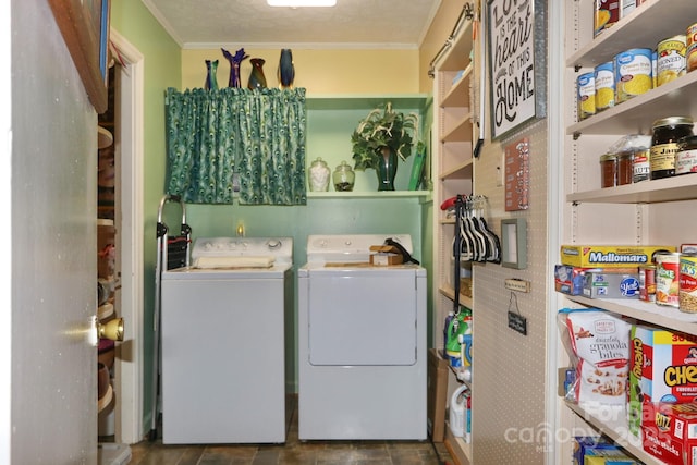 clothes washing area with ornamental molding and washer and clothes dryer