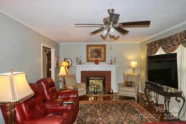 living room with crown molding, a brick fireplace, and ceiling fan