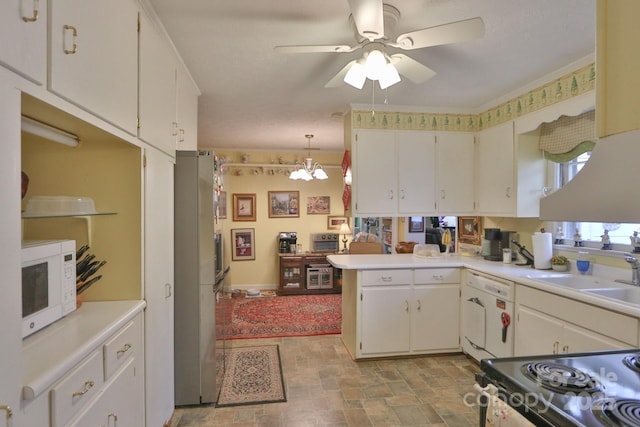 kitchen with white cabinetry, sink, decorative light fixtures, and kitchen peninsula