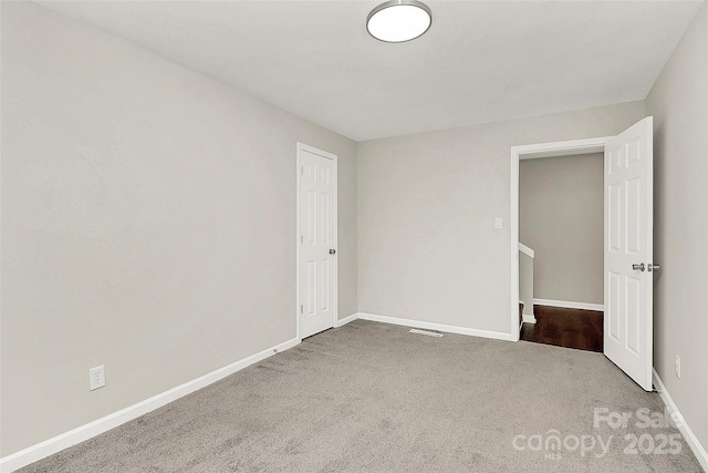 unfurnished bedroom with carpet flooring and baseboards