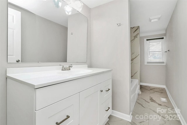 full bathroom featuring vanity, baseboards, and marble finish floor