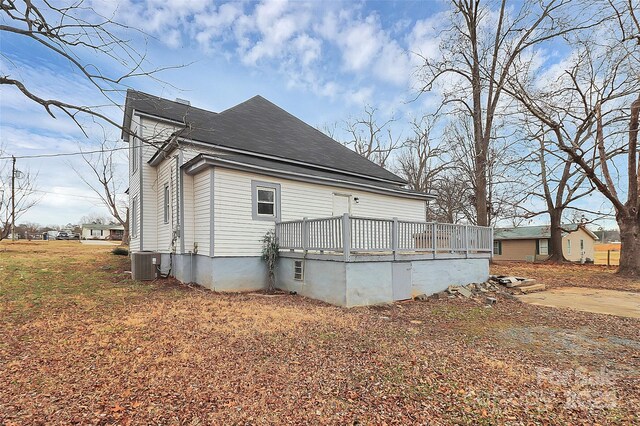 back of house with a wooden deck, central AC unit, and a shingled roof