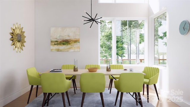 dining space with hardwood / wood-style flooring and a chandelier